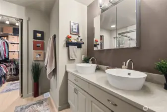 Recently remodeled primary bath, leading to a large walk-in closet.