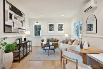 Sunlight fills a functional, open main level outfitted with engineered hardwood floors, mini-splits for heat and A/C, and a sleek chef's kitchen.