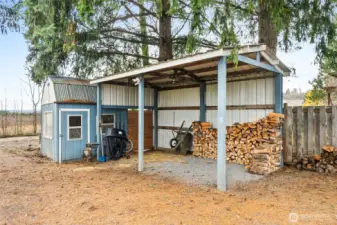 Handy shed and wood storage provide space for outdoor tools and a covered area to keep firewood neatly stacked and dry.  RV parking includes a sewer dump and 110 power accessible from the wood shed—previously home to a tiny house and chicken coop, offering flexible options for future use.