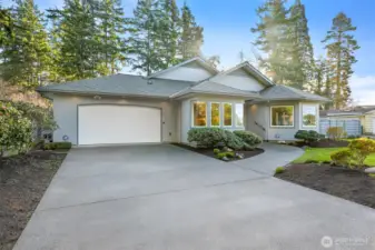 Inviting with long level driveway with parking for 5 cars and a 2-car garage.