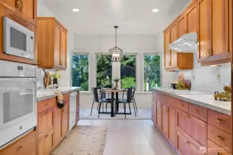 Galley kitchen with cozy breakfast nook for casual dining.