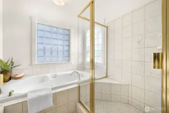 Primary bath features cherry linen closet, double vanity, jetted tub, tiled shower.