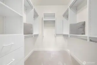 Custom walk-in closet offers ample space for your wardrobe.
