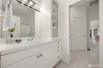 Full guest bath with convenient pocket door to laundry room.