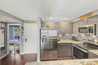 …as soon as walking in, the second bedroom on your right and a hard to miss gorgeous kitchen on your left.