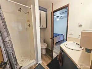 The bathroom connects to the bedroom, but is also accessible from the kitchen.