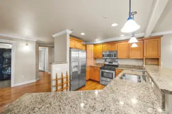 Kitchen has plenty of cabinet and counter space.  Door furthest on left leads to third bedroom.  Door closest is to utility room.