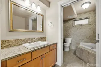 Primary bath with deep soaking tub, tiled heated floors.