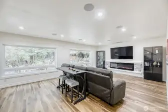 Open media room with electric fireplace puts out the heat or just the visual effect.