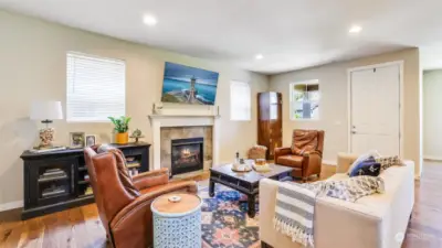 Living room boasts open floor plan, gas fireplace, recessing lighting, and stunning hardwood floors!