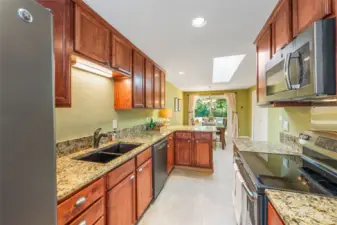 It's delightful having a garage to pull into, and then to drop wet clothing or shoes in the laundry room, and then enter this wonderful kitchen, ready to share food and good times! It's great to have this open plan view to the dining room and the new deck!