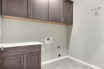 The upstairs laundry room is as functional as it is stylish, featuring upper cabinets for ample storage and a dedicated quartz countertop—perfect for folding, organizing, or additional storage. A well-designed space to make laundry day a breeze!