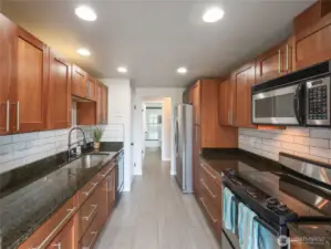 Custom Kitchen Cabinetry with LOADS of storage. White Subway tile backsplash is STUNNING!