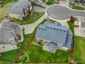Fully fenced backyard provides security for trash and recycling bins in separate area from backyard or front yard.