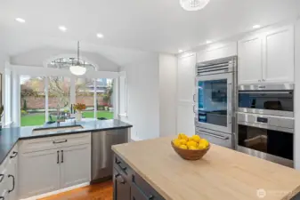 Outfitted with a Wolf speed oven/microwave, a Wolf convection oven, and a Sub-Zero commercial-grade stainless steel refrigerator, the kitchen delivers exceptional performance with premium design.