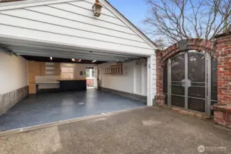 The spacious two-car garage features an Infratech radiant heater, built-in workbench, sink with Grohe faucet, and a new insulated Wayne Dalton 6600 Somerset carriage-style door with custom opener. Additional attic storage provides convenient overflow space for seasonal or infrequently used items.