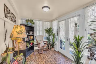 Enter the solarium through French doors. Vintage original floors