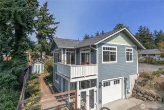 This view shows that the house is accessible from two levels. The upper level for the main level: LR, DR, view porch, kitchen, hall bath, Primary BR and primary bath.