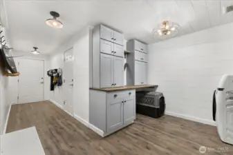 New ~permitted mud/laundry room addition. w/ Lots of storage. The doors lead to the garage, carport & dog run.