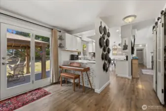 To the right is a pantry w/ antique sliding French doors. The microwave is in the pantry.