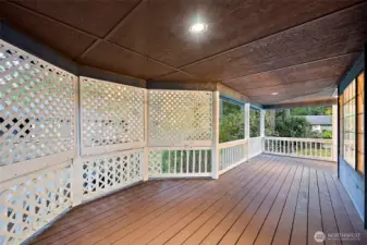 Covered side deck that wraps around from front porch to back deck, with some privacy screening from the neighbors.