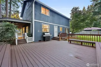 Huge back deck perfect for summer parties, and unwinding on the weekends. Back access of laundry room as well as side sliding door off kitchen.