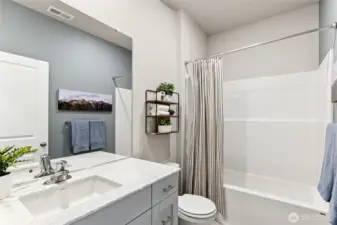 Large guest bathroom in the hall off bedroom 2 and 3 for convenience and privacy. Actual home is under construction. Colors, materials, and features may vary. See site agent for details.