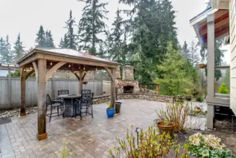 Back stone patio, gazebo and woodburning fireplace