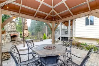 back gazebo, fireplace and steps to deck off kitchen