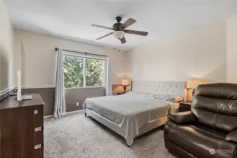 Upper level features this spacious primary bedroom with ceiling fan/light, window with views to the back yard.
