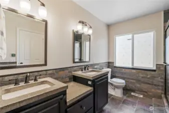 Fantastic primary bath with double vanities, large walk-in shower and slate floors.