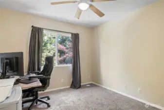 Second bedroom with ceiling fan/light currently being used as home office with views to the back yard.
