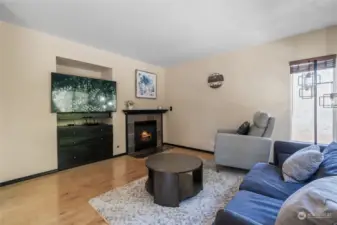 Family room off the kitchen area features a gas fireplace.