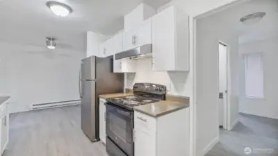 Perfectly positioned kitchen allows flow to all main living areas & the entries to the unit.