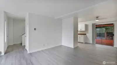 Spacious living room with beautifully updated LVP flooring that run throughout the main living space.