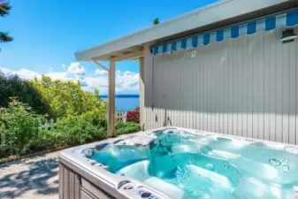 Th hot tub is located off the primary suite and front entrance.