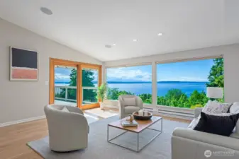 The living room has vaulted ceilings, refinished hardwood floors, access to the spacious deck and endless views.