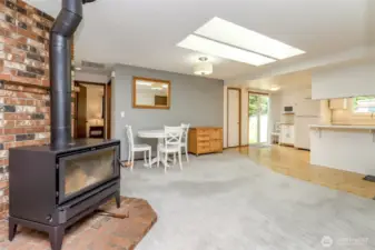 Close-up of wood stove and looking towards kitchen.