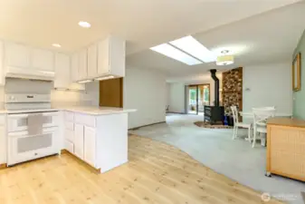 Kitchen has freshly painted cabinets, recessed lighting and a double oven.