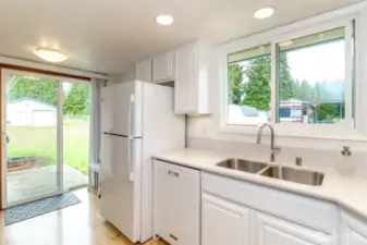 Another photo of the kitchen looking out the back door to the extra garage/workshop.