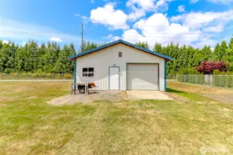 Here's the 28 x 28 foot garage/workshop. It has heaters, lights, workbench, pegboards, outlets and a concrete floor. Also a metal roof.