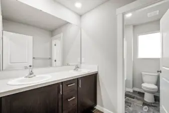Nice to have a door on the water closet in the guest bath. Photos are for representational purposes only. Some colors and finishes may differ.