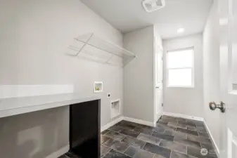 Utility room will have built in cabinets and folding table. Photos are for representational purposes only. Some colors and finishes may differ.