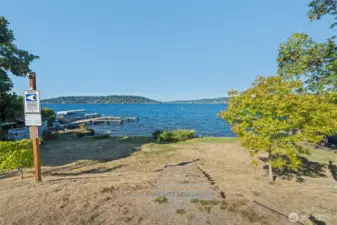 Steps leading down to the shared beach, offering easy access to the lake and sweeping water views.