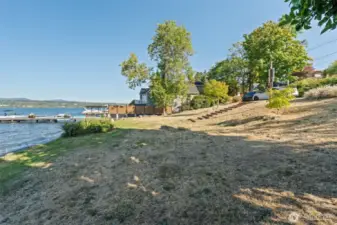 Gently sloped lawn leading to the shoreline, perfect for lakeside lounging and enjoying the outdoors.