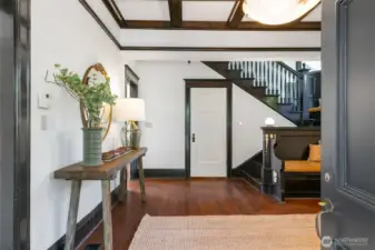 The grand entry  welcomes you with generous scale, box beam ceilings, stained glass windows and original millwork