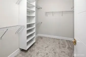 built-in shelving in primary walk-in closet