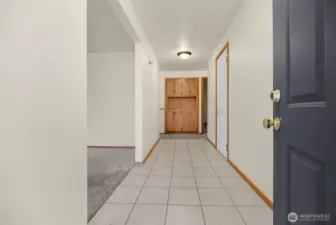 Freshly painted front door into large entry hallway.