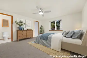 Primary Bedroom at the end of the hall with walk-in closet (door on right) + step in shower.