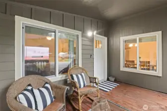 Covered front porch offering a comfortable, year-round outdoor seating space.